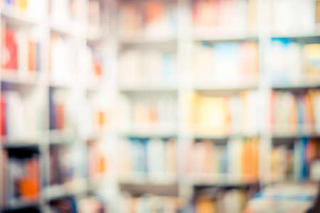 White bookcase with many colored books. Blurred backgroundの写真素材