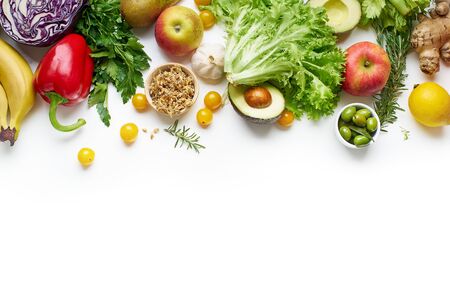 Various healthy raw organic vegetables, herbs, sprouts and fruits isolated on white background. Top view vegetarian food with copy spaceの写真素材
