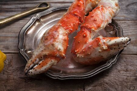 Fresh crab claws on vintage wooden background. Composition with copy spaceの写真素材