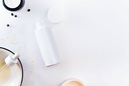 Photographic horizontal mockup with one white unnamed tube of elite cosmetics, organic oil and juniper berriesの写真素材