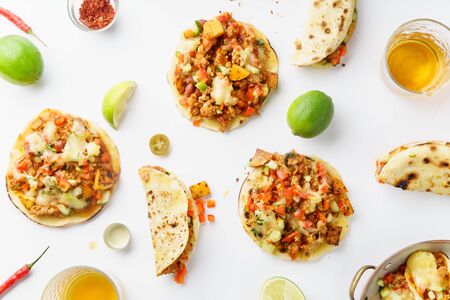 Mexican tacos with chili con carne, grilled sweet potatoes and grated cheese on white background. Text spaceの写真素材