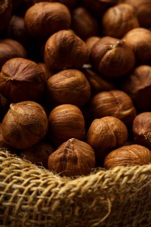 A handful of raw hazelnuts in textile bag. の写真素材