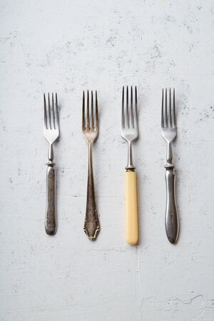 Various vintage forks on concrete backgroundの写真素材