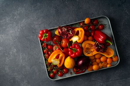 Flatlay with fresh colorful vegetables arranged on metallic tray on gray concrete background. Set of vegetarian ingredients concept. Copy space.の写真素材