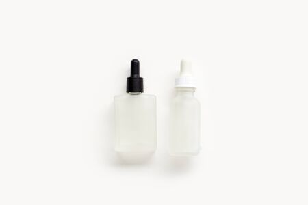 Serum bottles on white background. Cosmetic flatlay