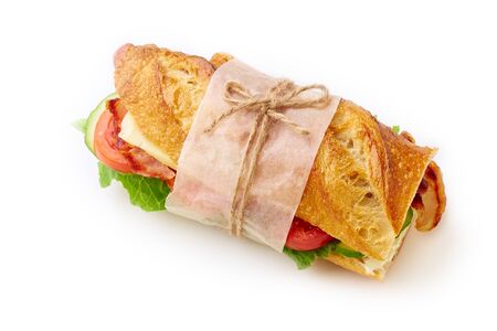 Fresh big baguette sandwich with bacon, chedder cheese, mustard, lettuce and vegetables isolated on white backgroundの写真素材