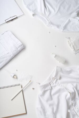 White monochromatic flatlay on white background. Clothes, accessories, stationery and beauty equipment. Blog design conceptの写真素材