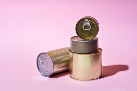 Non-perishable canned goods on colorful background. Pandemic kit staple. Food food staples prepared to survive Coronavirus COVID 19 pandemic at the time of quarantine and home isolationの写真素材