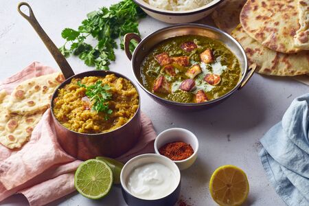 Top view indian cuisine dinner: tandoori chicken, biryani, red lentil curry dal with rice naan, palak paneer and basmati riceの写真素材