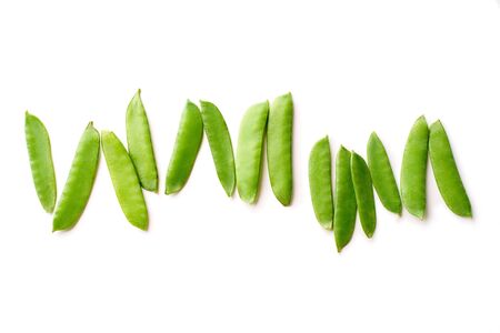 Top view image of fresh thin snow peas isolated on white background. View from above with copy space. Healthy vegetarian meal ingredientの写真素材