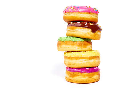 A pile of glazed donuts isolated on white background with copy space. Junk foodの写真素材