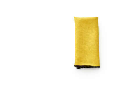Flat lay with yellow linen kitchen napkin isolated on white background. Folded cloth for mockup with copy spaceの写真素材