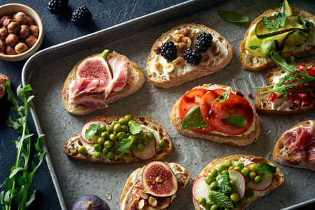 Closeup top view of various bruschettas with toppings. Snack finger food meal for wine, starter.の写真素材