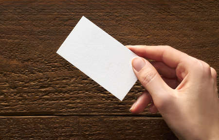 Modern business card mockup template on gray background. Top view flat lay of a card. Mock-up design for branding, advertising and designの写真素材