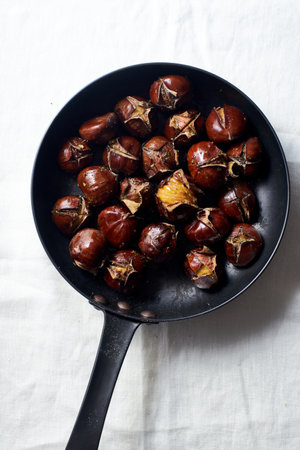 Top view of roasted chestnuts in a frying pan.の写真素材