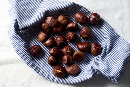 Top view of roasted chestnuts in a frying pan.