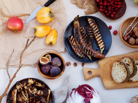 Flat lay seasonal vegetables, fruits and bread, healthy vegetarian ingredients. Grilled aubergines and mushroomsの写真素材