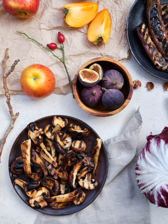 Flat lay seasonal vegetables, fruits and bread, healthy vegetarian ingredients. Grilled aubergines and mushroomsの写真素材