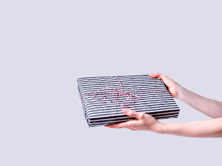 Holiday gift box in hands of a female modelの写真素材