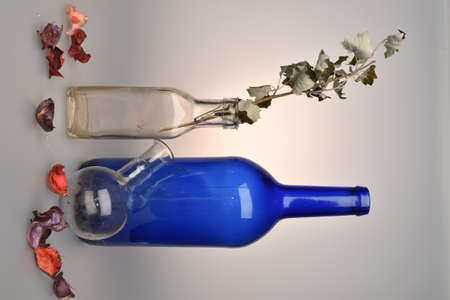 glass bottles and autumn leaves in a studioの写真素材