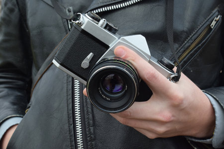 photographer holding old vintage film cameraの写真素材