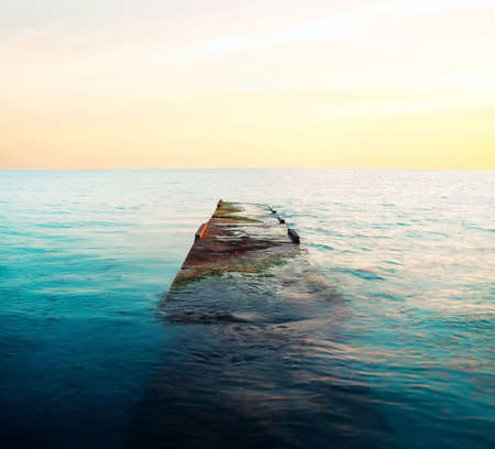 Flooded stone pier at sunset in the city of Sochiの写真素材