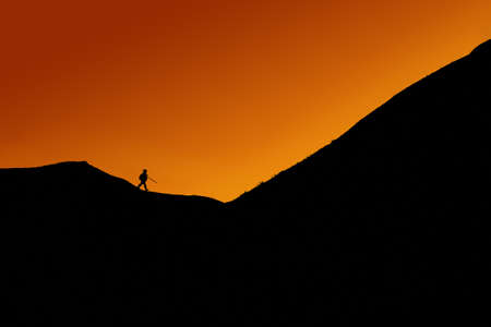 Santa is on the hill at sunset with a bag of giftsの写真素材