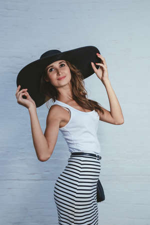 brunette in a hat with large fields