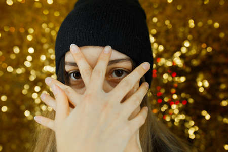 women dressed black having fun in night clubs photographed on gold background girl have black scarf with stars them red lipstick and they are very funnyの写真素材