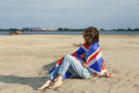 portrait girl the beach dawn she denim overalls white t-shirt British moistureの写真素材