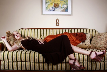 blond girl lying on sofa