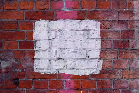 white color square on red brick wall backgroundの写真素材