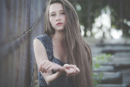 portrait of a beautiful young sad hipster girl  outdoors at the day timeの写真素材