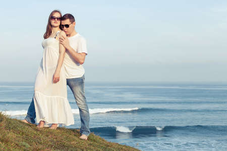 Loving couple standing on the beach at the day time. Concept of friendly family.の写真素材