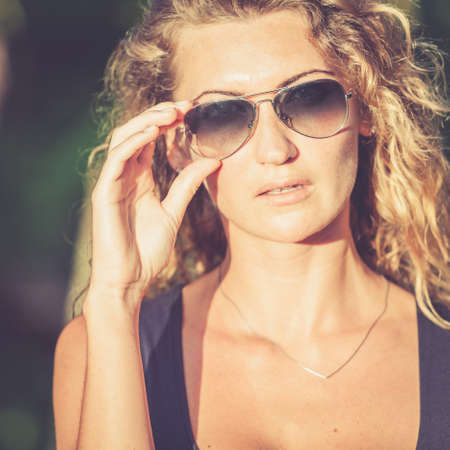 portrait of a beautiful blonde girl with sunglassesの写真素材