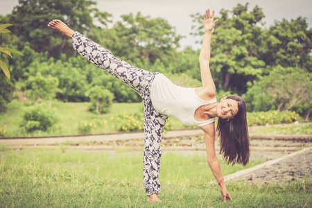 Yoga. Young woman doing yoga exercise outdoor at the day time.の写真素材