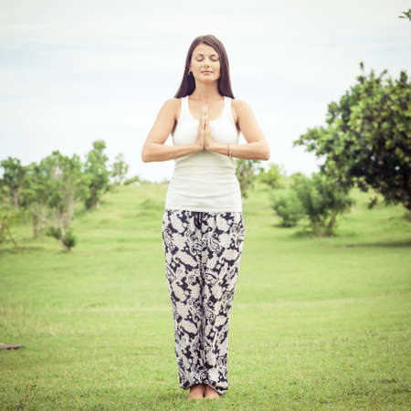 Yoga. Young woman doing yoga exercise outdoor at the day time.の写真素材