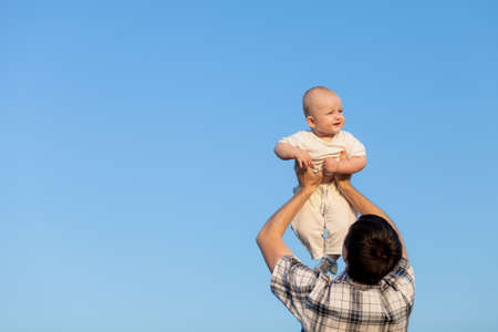 Happy family playing in park at the day time. Father and son having fun on the nature. Concept of...