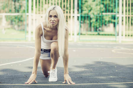 Sports girl sitting outdoors at the day time. Concept of healthy life.の写真素材