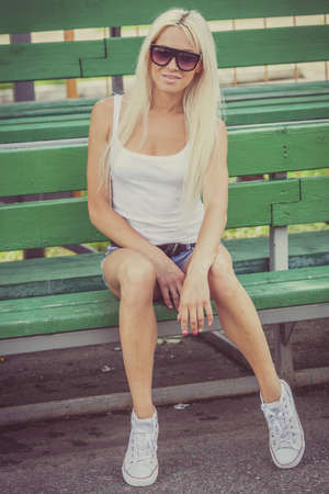 Sports girl sitting outdoors at the day time. Concept of healthy life.の写真素材