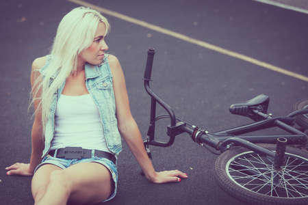 Sports girl sitting outdoors at the day time. Concept of healthy life.の写真素材
