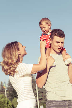 Happy family playing in park at the day time. People having fun on the nature. Concept of happiness.の写真素材