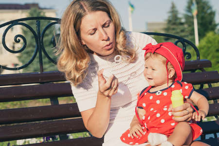Happy mother and daughter playing in park at the day time. People having fun on the nature. Concept...
