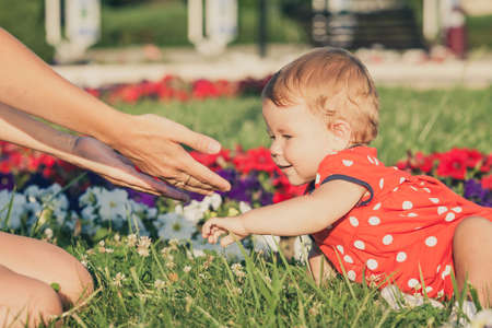 Happy mother and daughter playing in park at the day time. People having fun on the nature. Concept of happiness.の写真素材