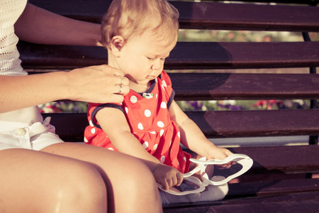 Happy mother and daughter playing in park at the day time. People having fun on the nature. Concept of happiness.の写真素材