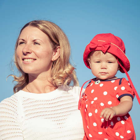 Happy mother and daughter playing in park at the day time. People having fun on the nature. Concept of happiness.の写真素材