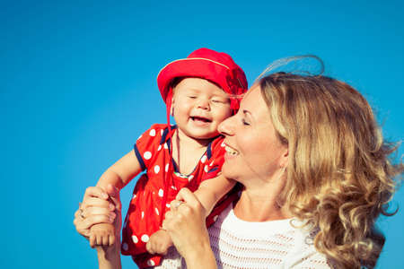 Happy mother and daughter playing in park at the day time. People having fun on the nature. Concept...