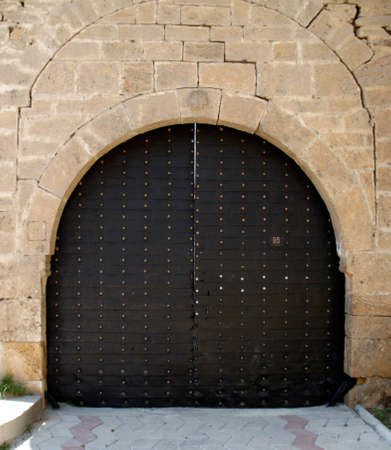 Traditional old big Ottoman iron door and aged wall in Macedoniadoniaのeditorial素材