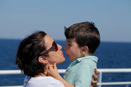 Mother and sun enjoying ride on a public ferryの写真素材