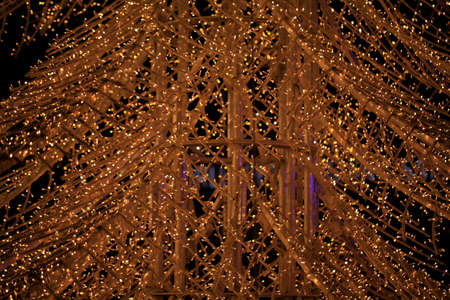 Close up detail to a christmas tree with lights at night